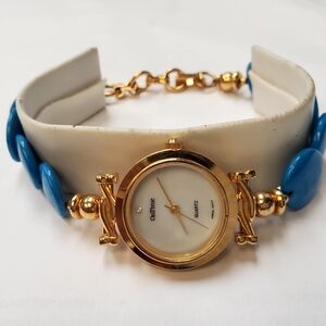 ON TIME WATCH GOLDTONE WITH MOP FACE AND TURQUOISE BAND 8in.